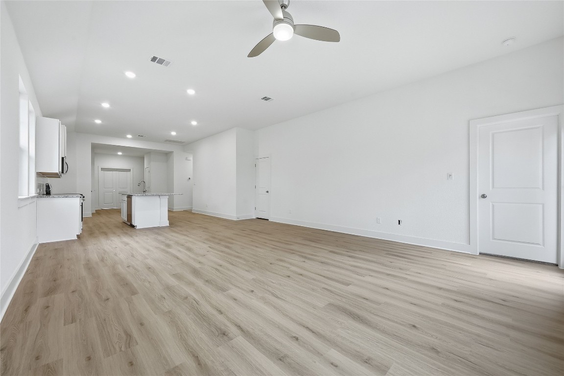 20308 Boggy Ford Road Lago Vista, TX 78645 - Photo 13 of 25 a view of empty room with wooden floor