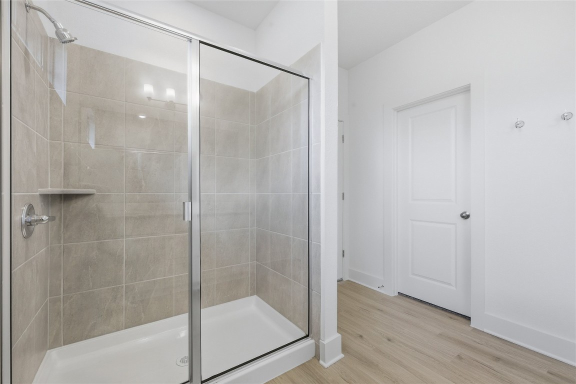 20308 Boggy Ford Road Lago Vista, TX 78645 - Photo 17 of 25 a bathroom with a glass shower door