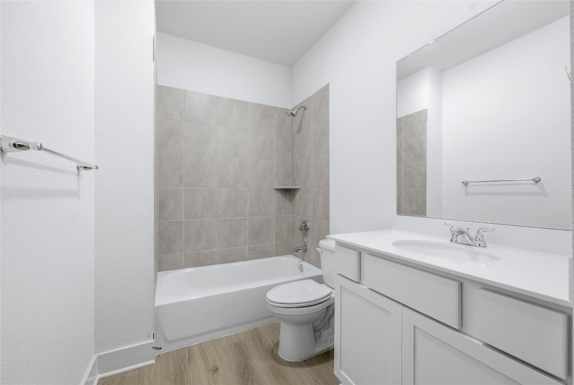 20308 Boggy Ford Road Lago Vista, TX 78645 - Photo 21 of 25 a bathroom with a sink a toilet and shower