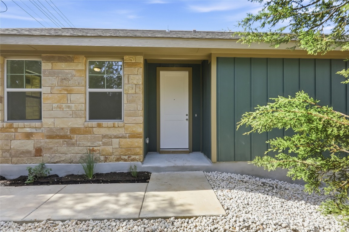20308 Boggy Ford Road Lago Vista, TX 78645 - Photo 5 of 25 a front view of a house with a garden
