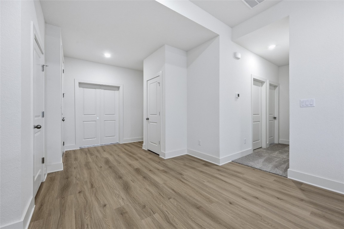 20308 Boggy Ford Road Lago Vista, TX 78645 - Photo 7 of 25 a view of an empty room with wooden floor