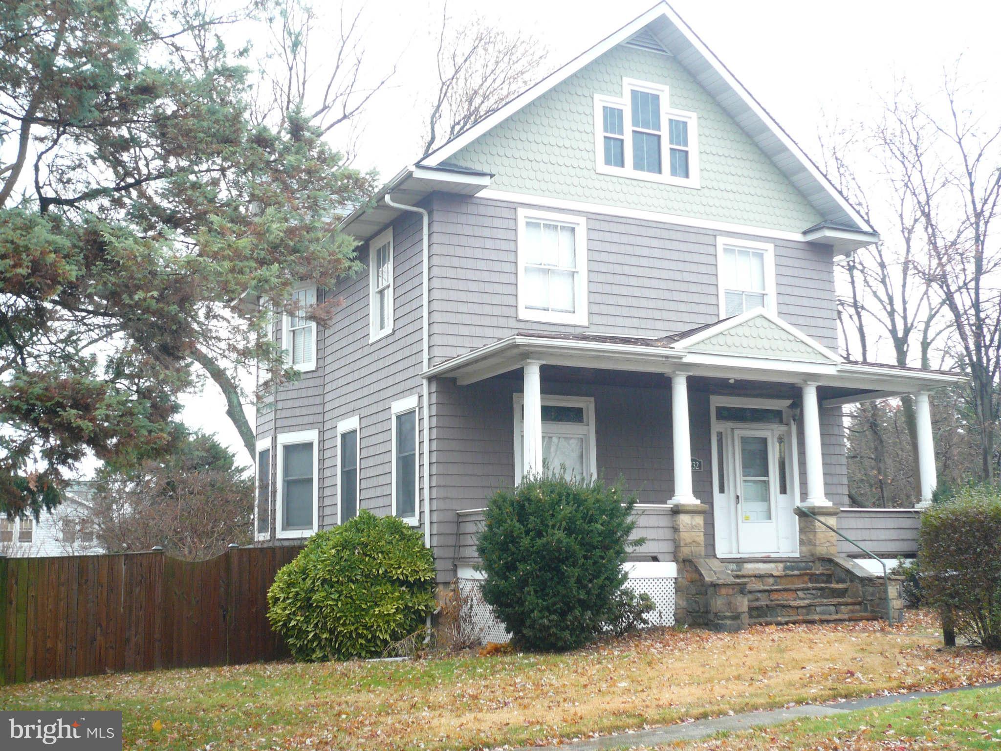 5232 Tramore Road Baltimore, MD 21214 - Photo 1 of 20 a view of a white house next to a yard with big trees