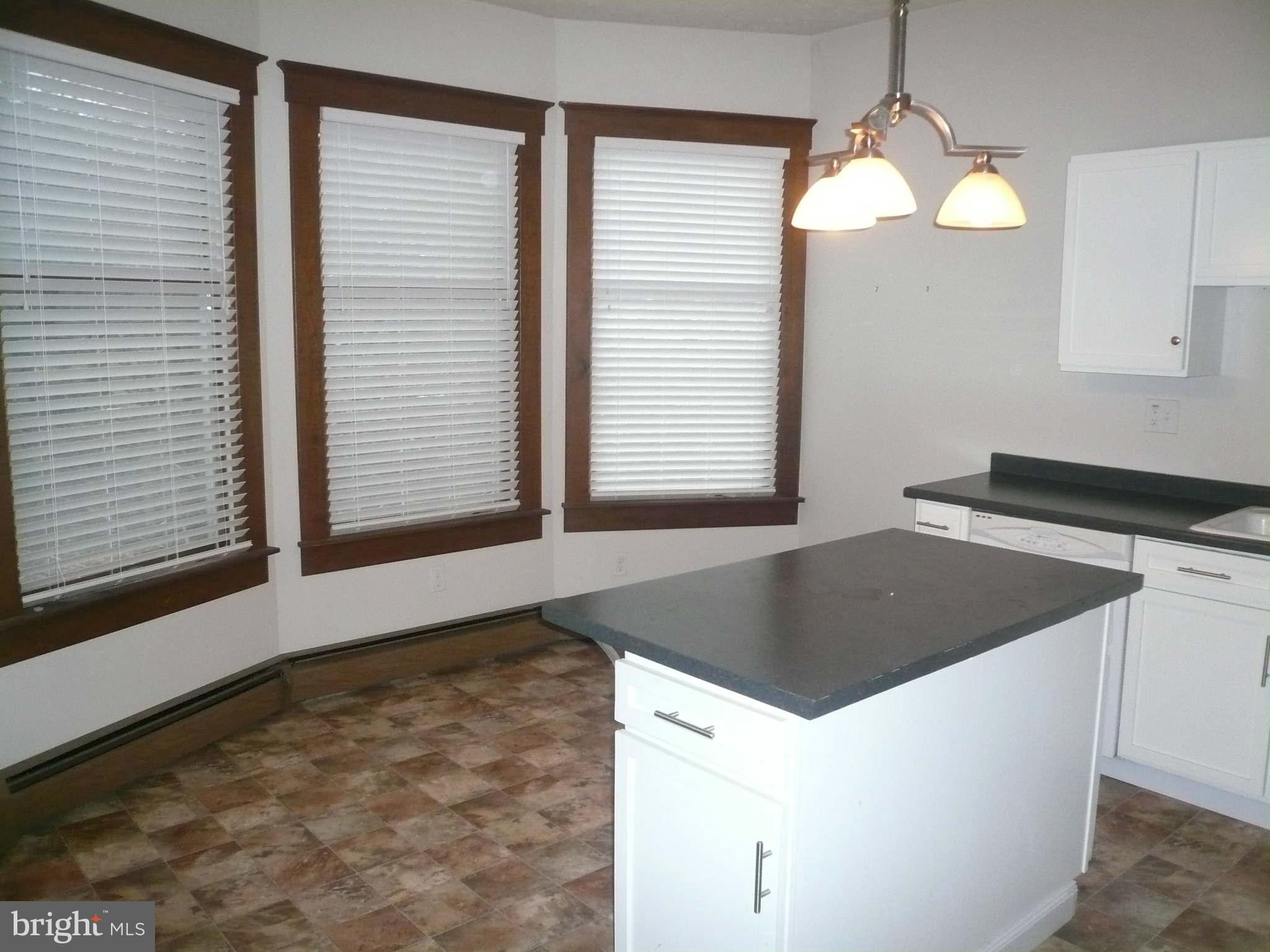 5232 Tramore Road Baltimore, MD 21214 - Photo 5 of 20 a kitchen with a stove and a cabinet