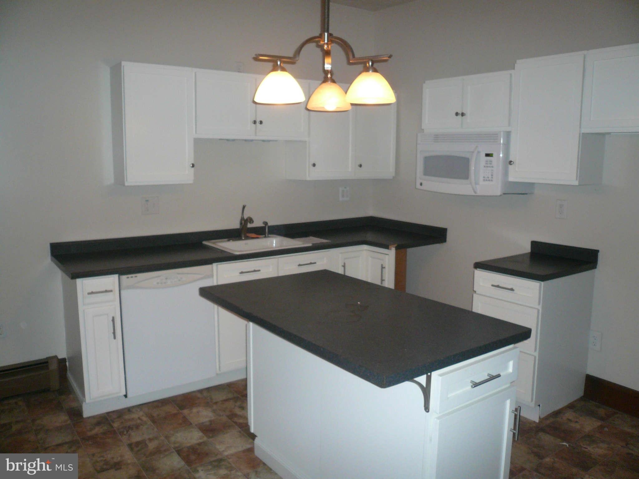 5232 Tramore Road Baltimore, MD 21214 - Photo 6 of 20 a kitchen with granite countertop a sink a stove and cabinets