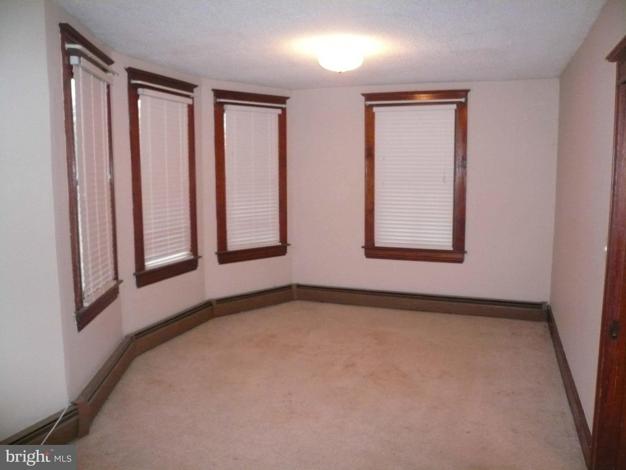 5232 Tramore Road Baltimore, MD 21214 - Photo 9 of 20 a view of an empty room with windows