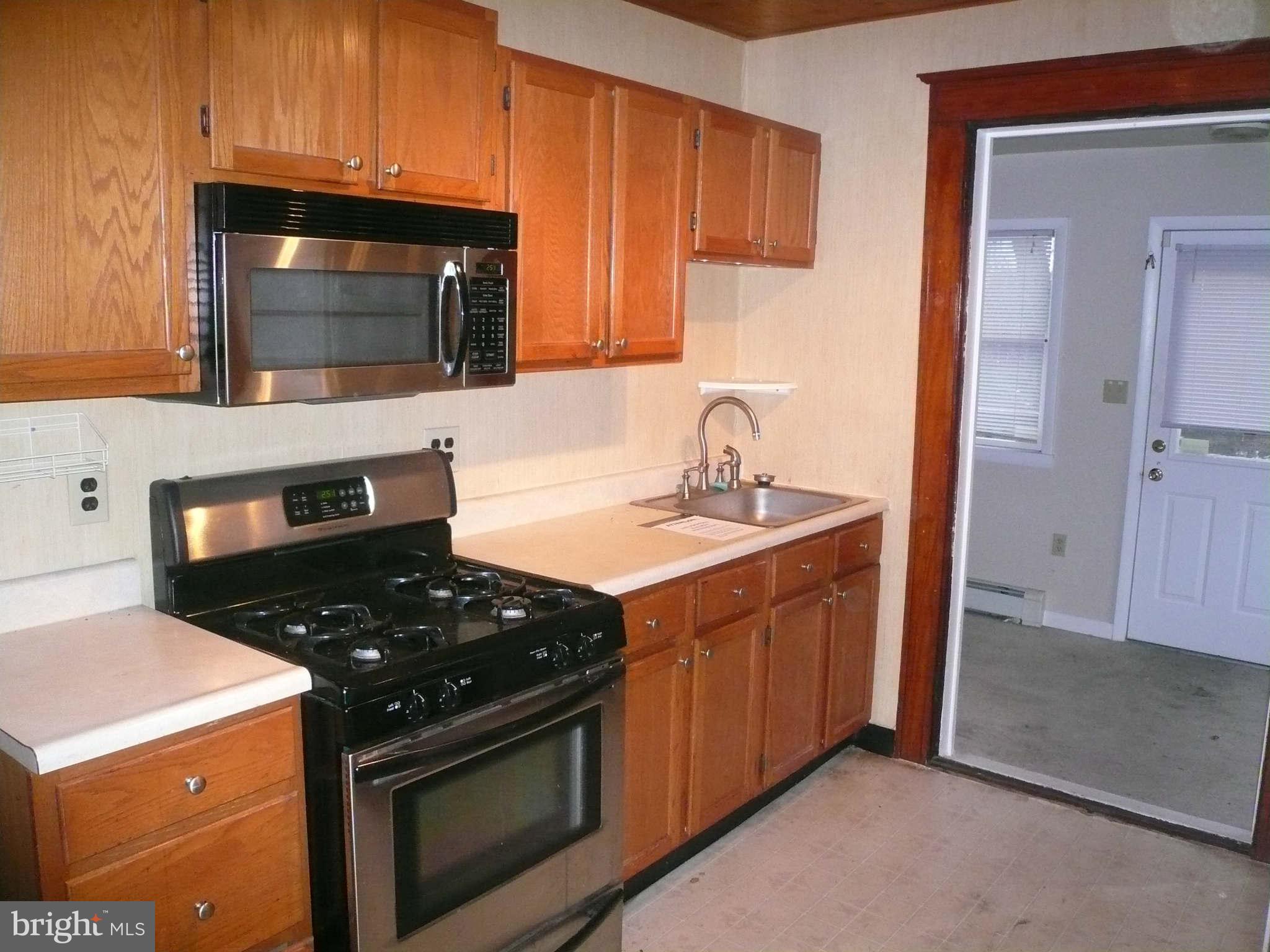 5232 Tramore Road Baltimore, MD 21214 - Photo 10 of 20 a kitchen with a stove and a microwave