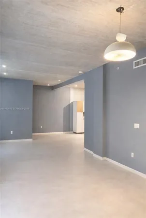 a view of an empty room with a chandelier