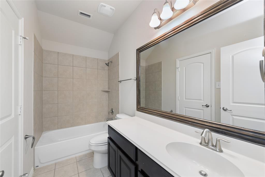 12571 Valley Spring Drive Frisco, TX 75035 - Photo 30 of 39 a bathroom with a sink a toilet and shower