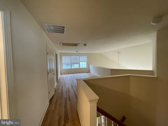 a view of hallway with wooden floor