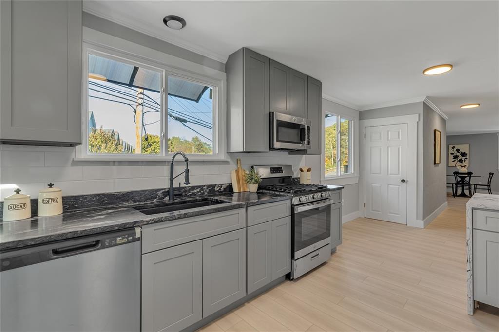 601 Center Avenue Pittsburgh, PA 15202 - Photo 11 of 48 a kitchen with stainless steel appliances granite countertop a sink stove and refrigerator