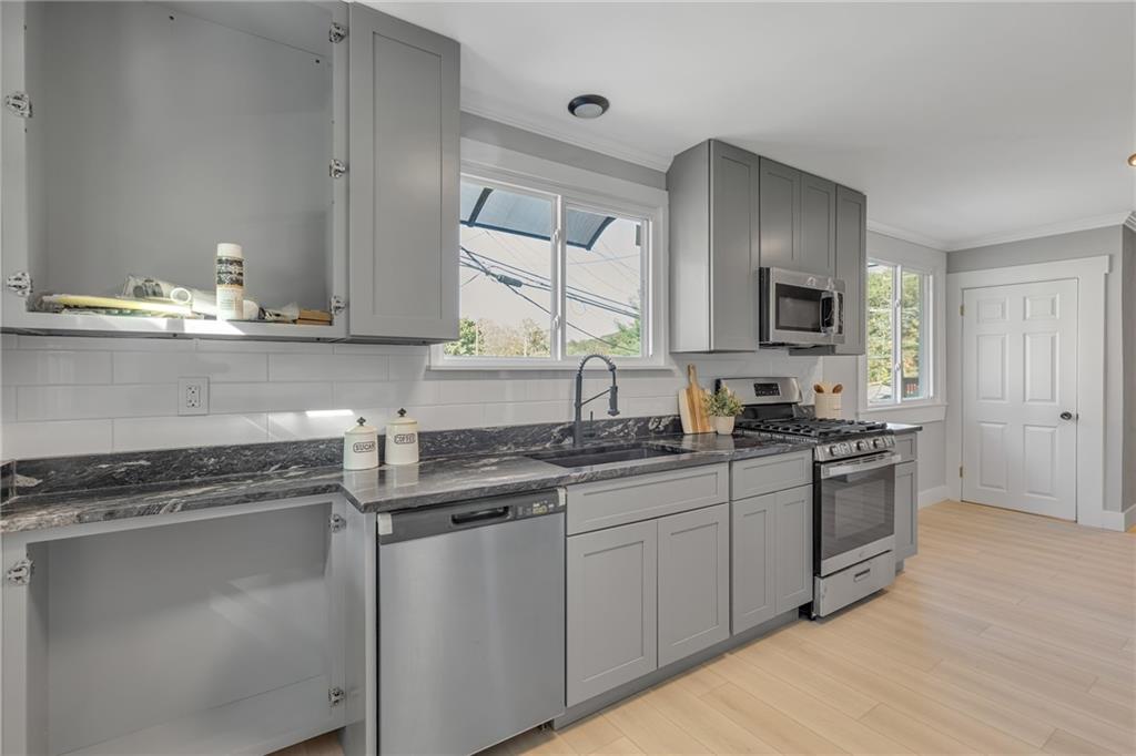 601 Center Avenue Pittsburgh, PA 15202 - Photo 10 of 48 a kitchen with stainless steel appliances granite countertop a sink stove and cabinets
