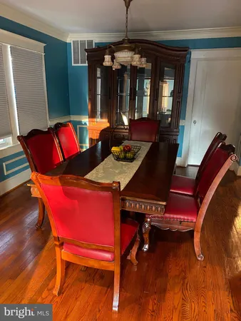 a view of a dining room with furniture and chandelier