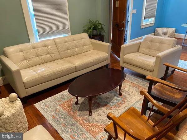 a living room with furniture and a rug