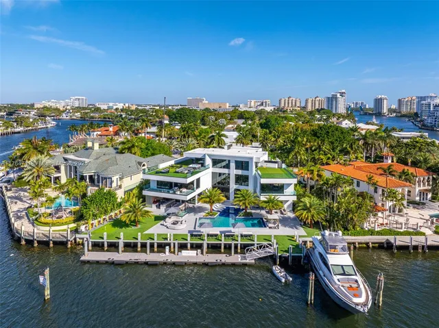 a living room with furniture a chandelier and a fireplace