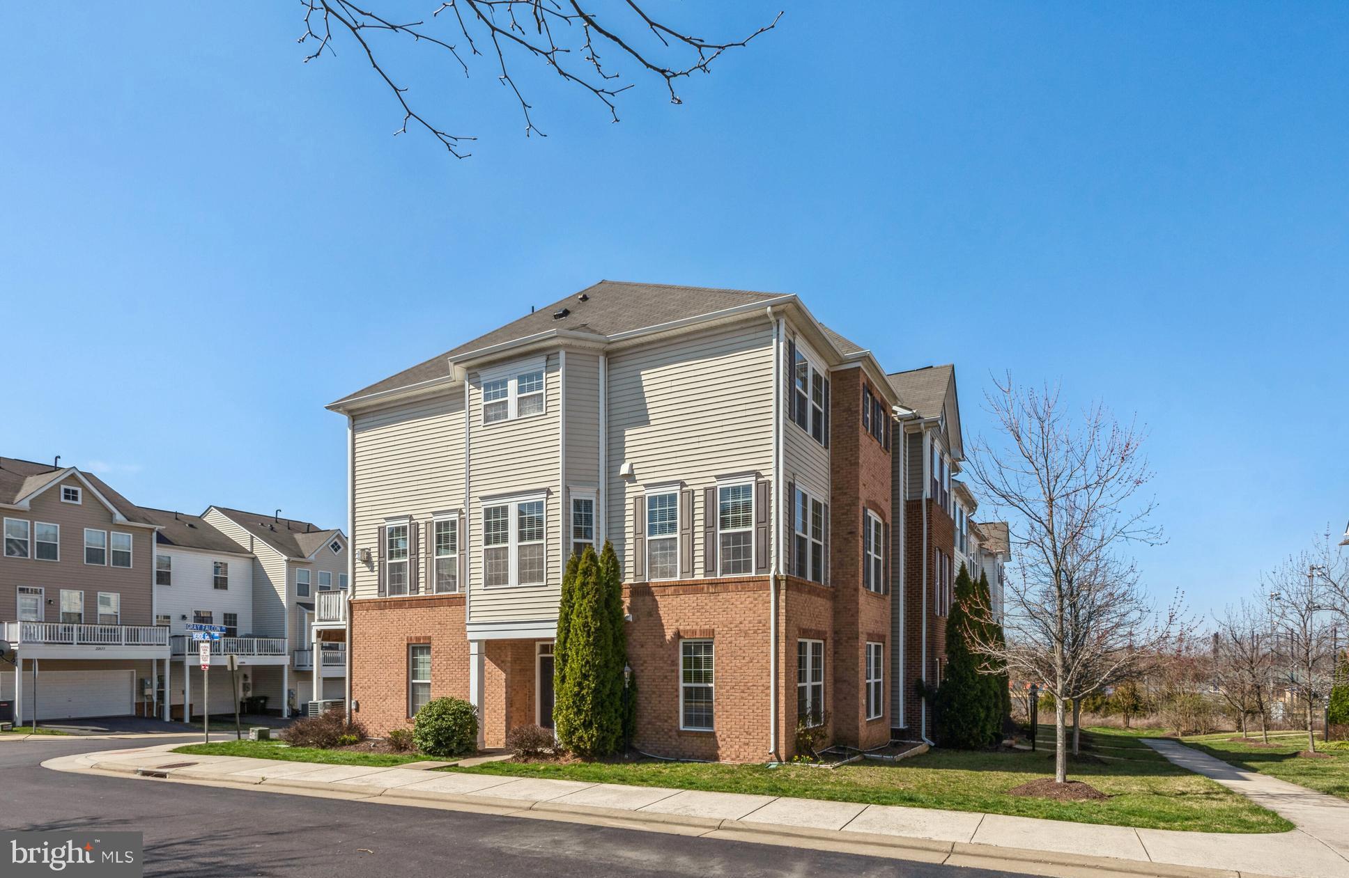 a front view of a building with a garden