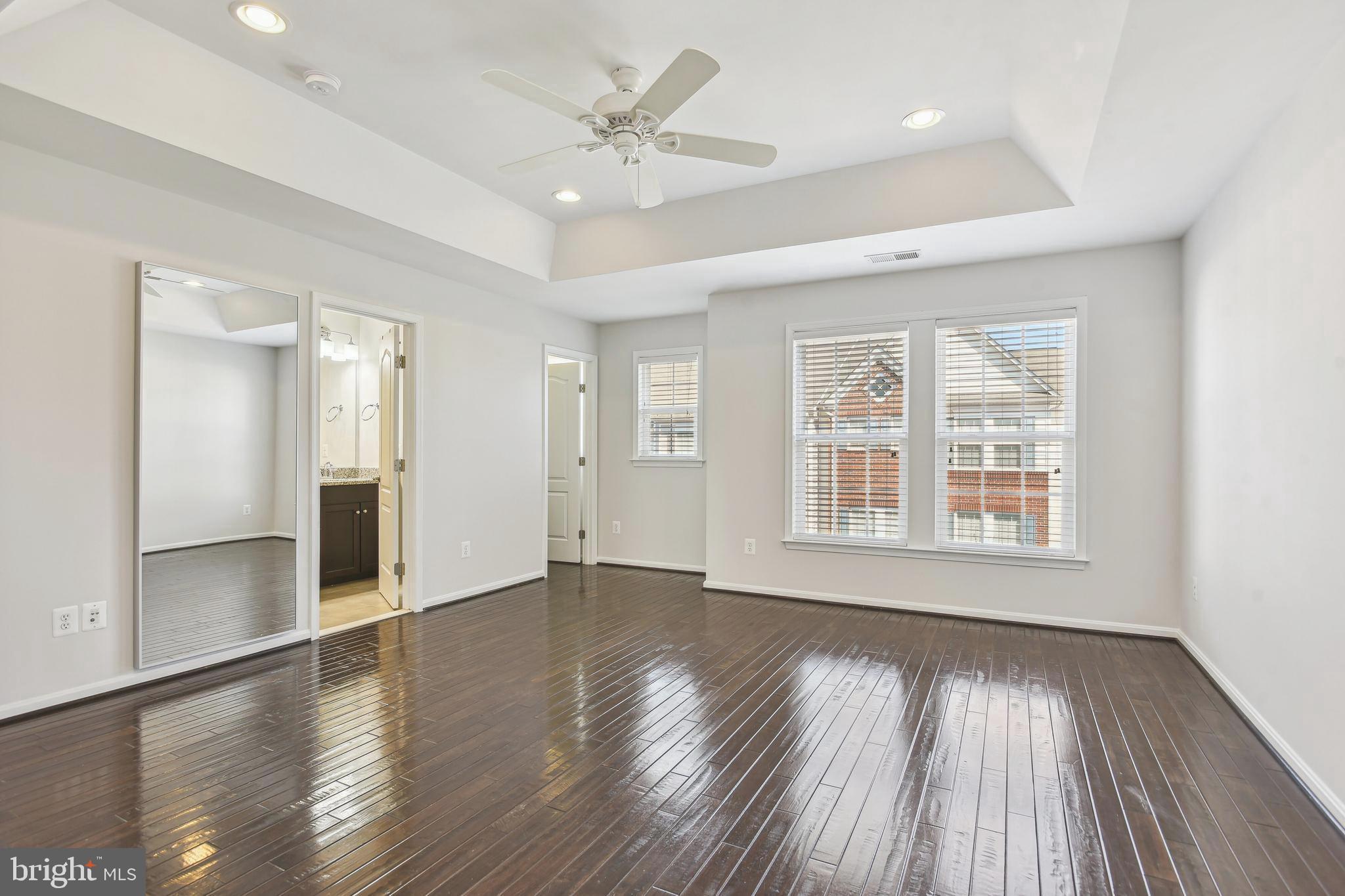 22652 Gray Falcon Square Ashburn, VA 20148 - Photo 12 of 24 a view of an empty room with wooden floor and a window
