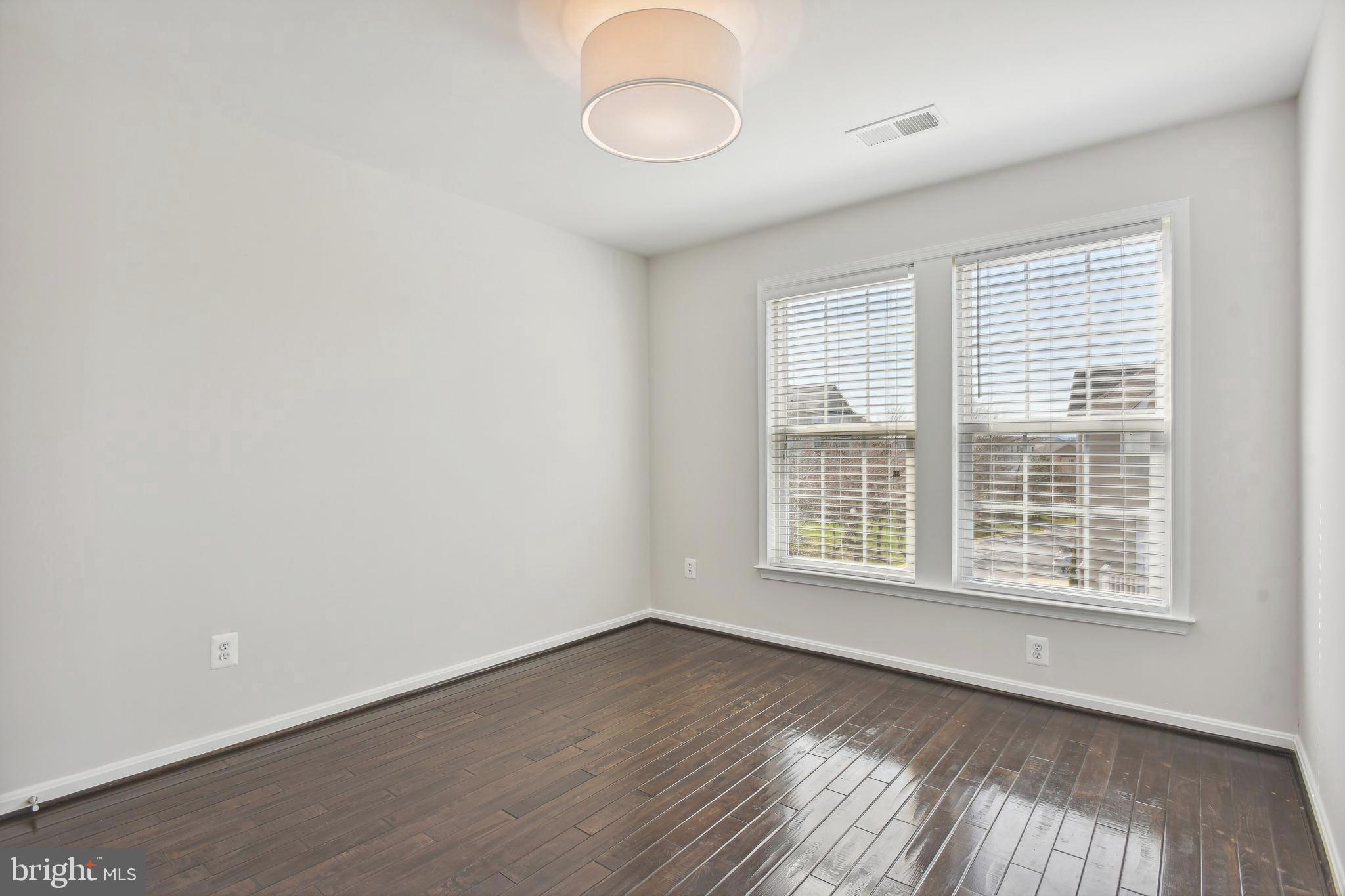 22652 Gray Falcon Square Ashburn, VA 20148 - Photo 17 of 24 an empty room with wooden floor and windows