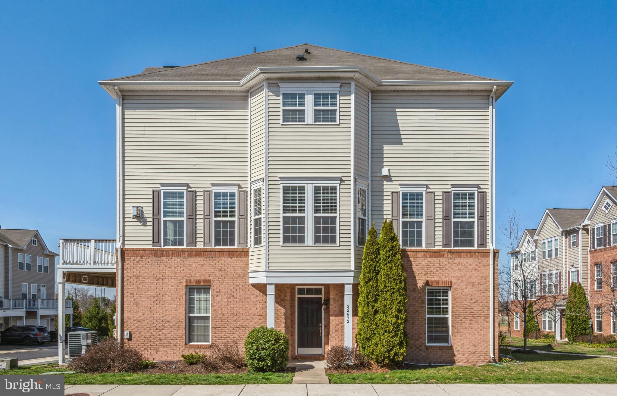 22652 Gray Falcon Square Ashburn, VA 20148 - Photo 2 of 24 a front view of a house with a yard