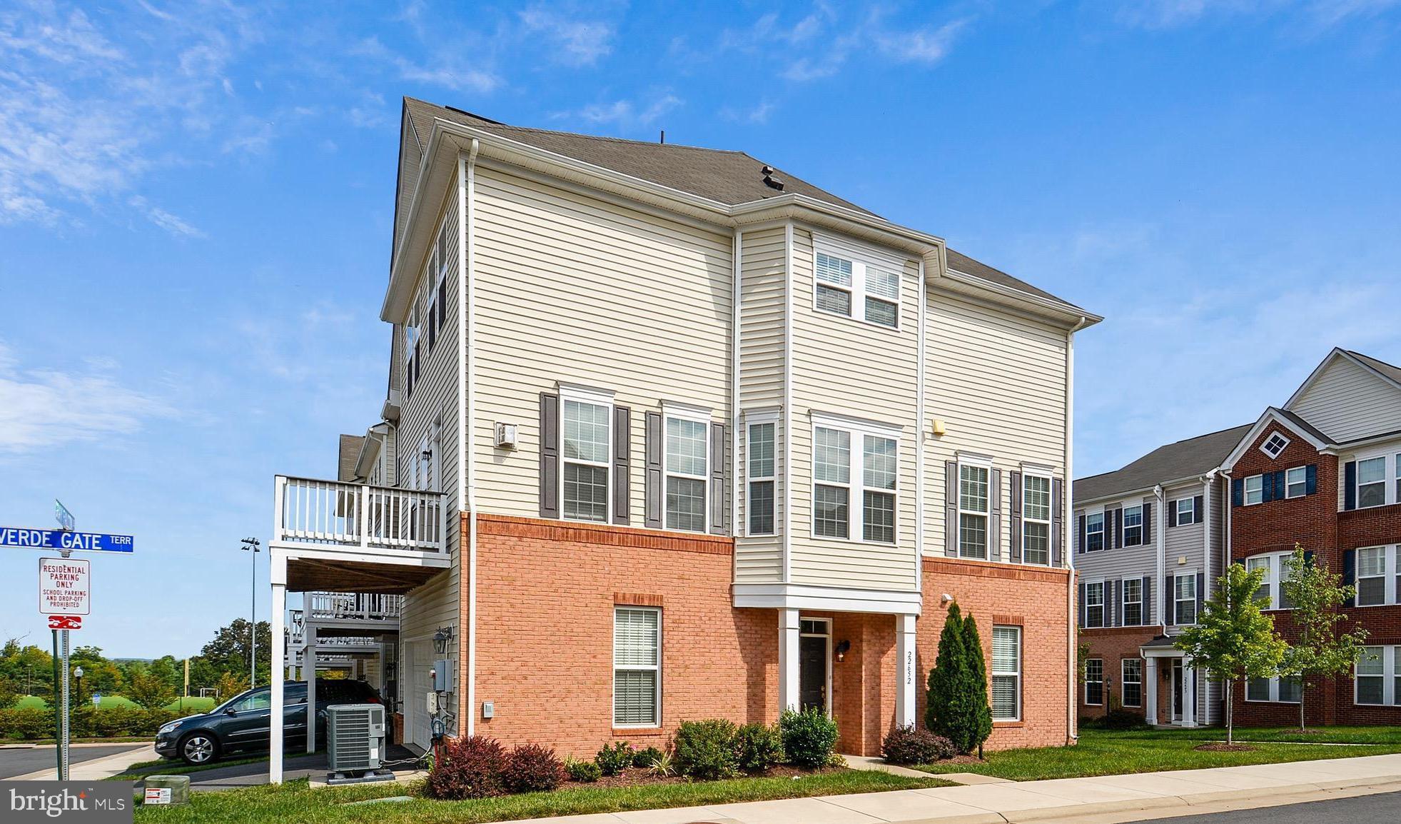 22652 Gray Falcon Square Ashburn, VA 20148 - Photo 3 of 24 a front view of a residential apartment building with a yard