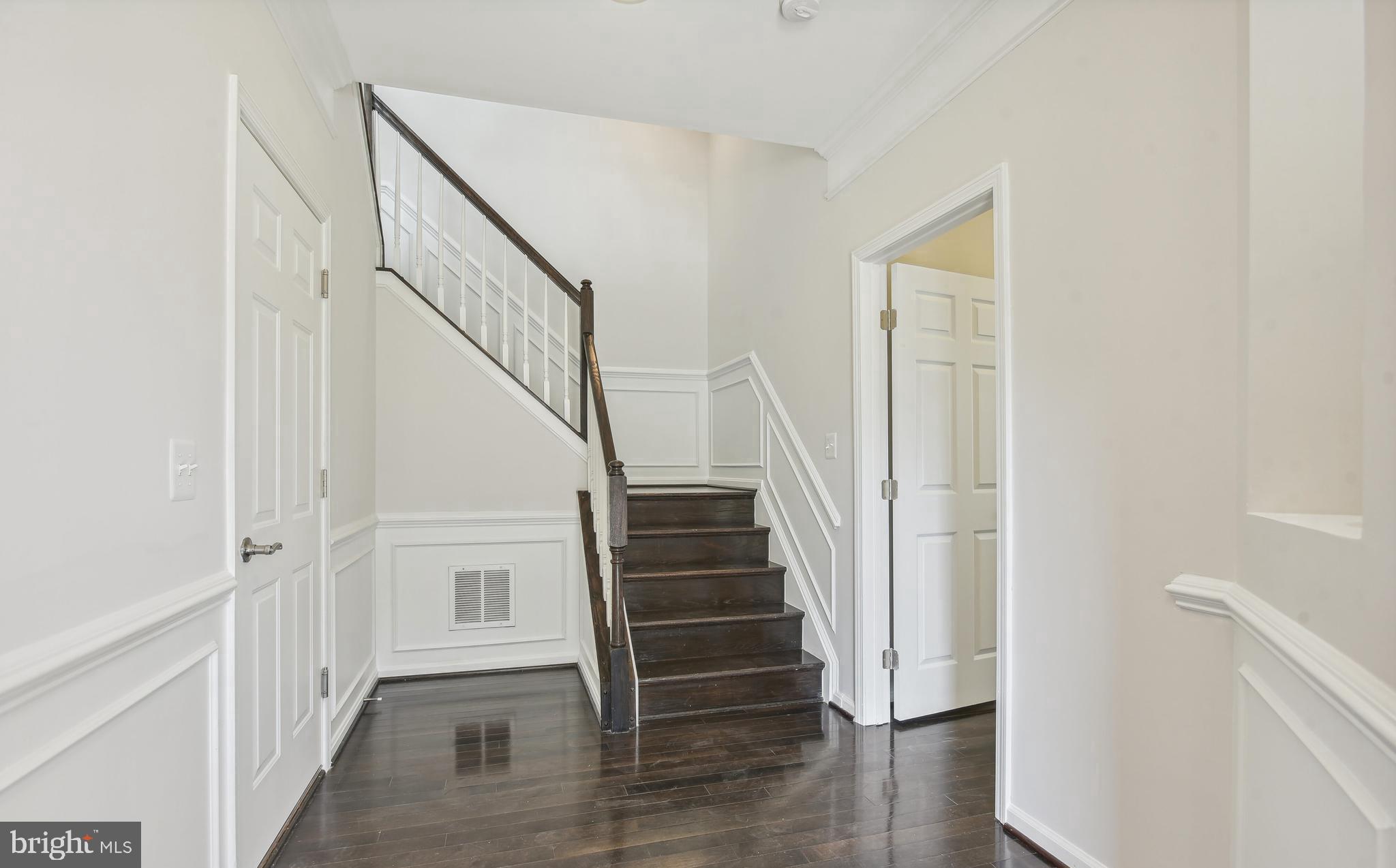 22652 Gray Falcon Square Ashburn, VA 20148 - Photo 4 of 24 a view of a hallway with wooden floor and entryway