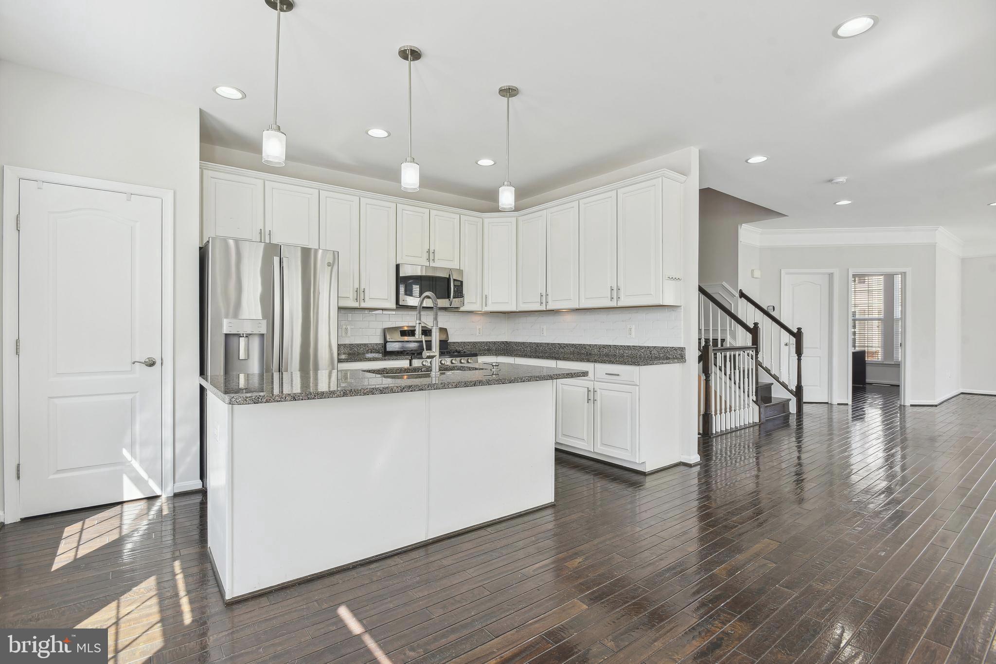 22652 Gray Falcon Square Ashburn, VA 20148 - Photo 6 of 24 a kitchen with stainless steel appliances granite countertop a refrigerator a sink and a oven