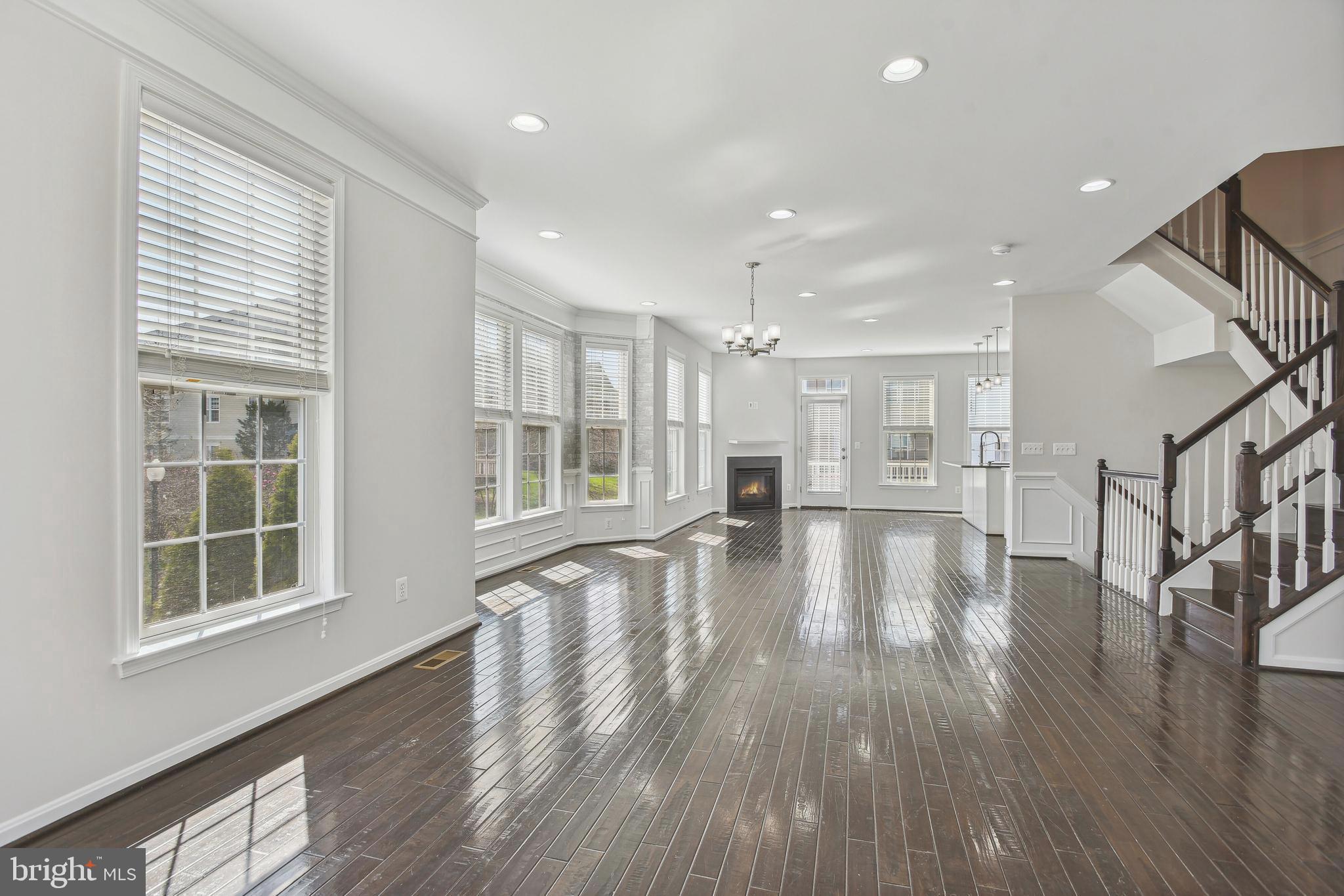 22652 Gray Falcon Square Ashburn, VA 20148 - Photo 10 of 24 a view of empty room with wooden floor and windows