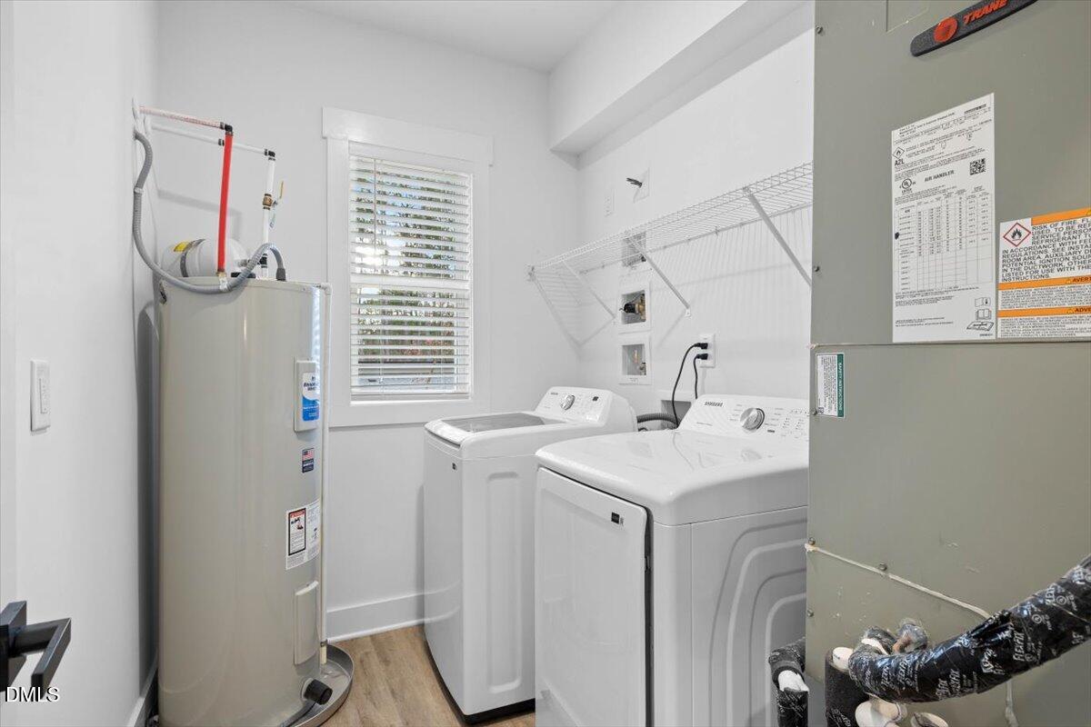 929 Jasmine Road Fuquay-Varina, NC 27526 - Photo 22 of 27 a utility room with cabinets washer and dryer