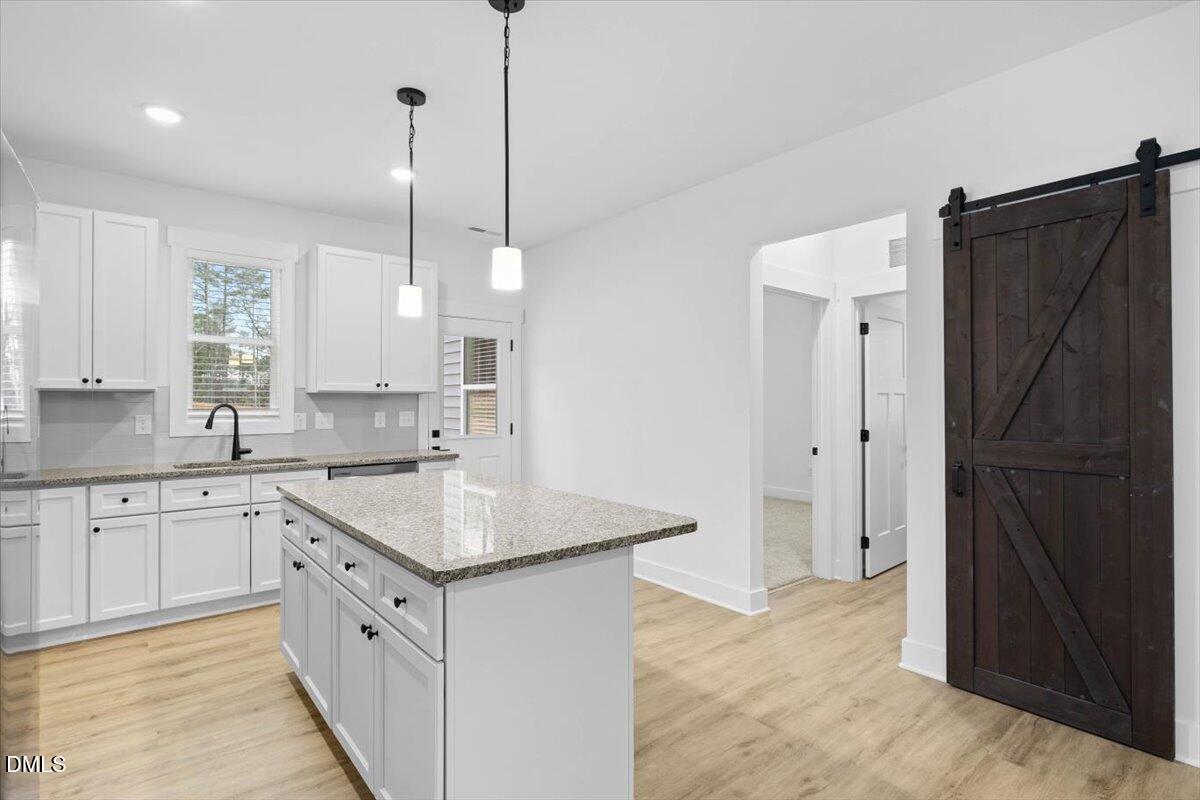 929 Jasmine Road Fuquay-Varina, NC 27526 - Photo 4 of 27 a kitchen with white cabinets and refrigerator