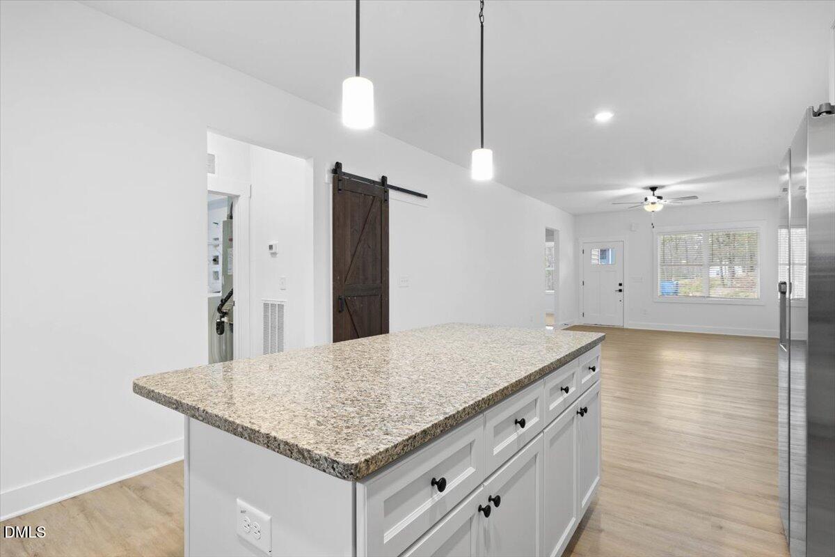 929 Jasmine Road Fuquay-Varina, NC 27526 - Photo 5 of 27 a kitchen with stainless steel appliances granite countertop a sink and a refrigerator