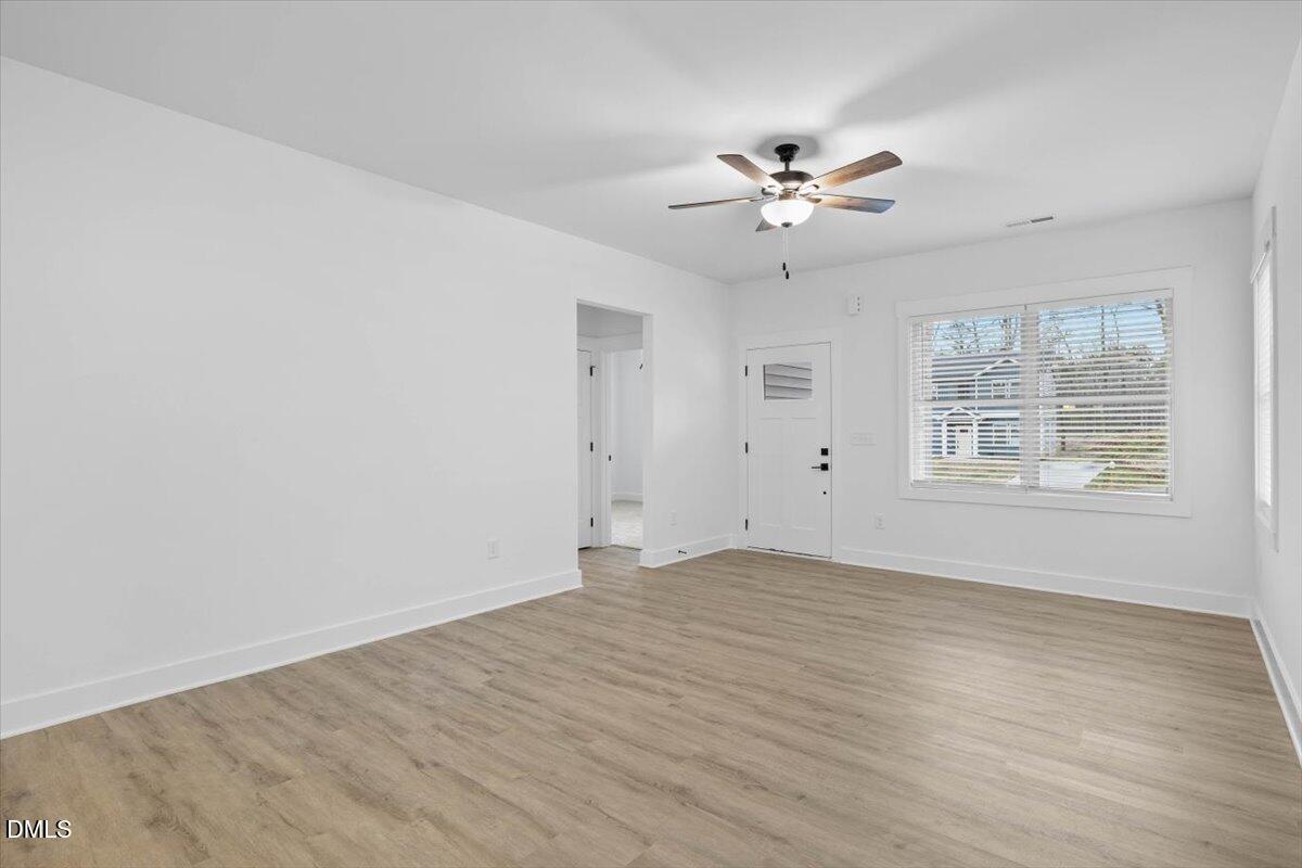 929 Jasmine Road Fuquay-Varina, NC 27526 - Photo 9 of 27 wooden floor in an empty room with a window