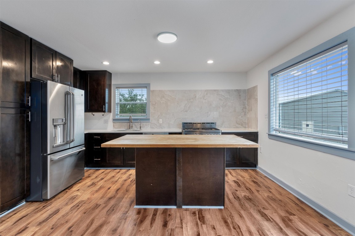 1100 High Road San Marcos, TX 78666 - Photo 4 of 36 a kitchen with kitchen island wooden floors appliances and cabinets