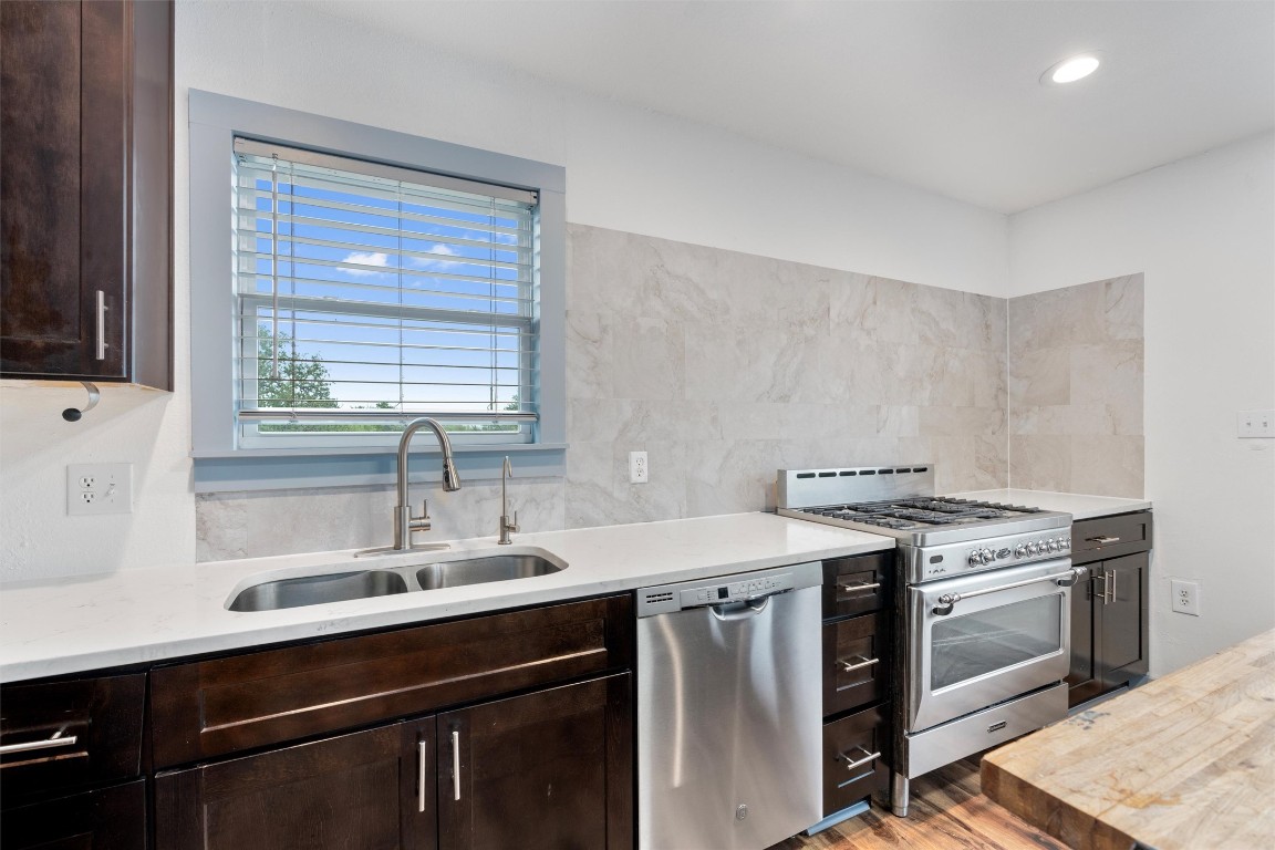1100 High Road San Marcos, TX 78666 - Photo 6 of 36 a kitchen with a sink stove and cabinets
