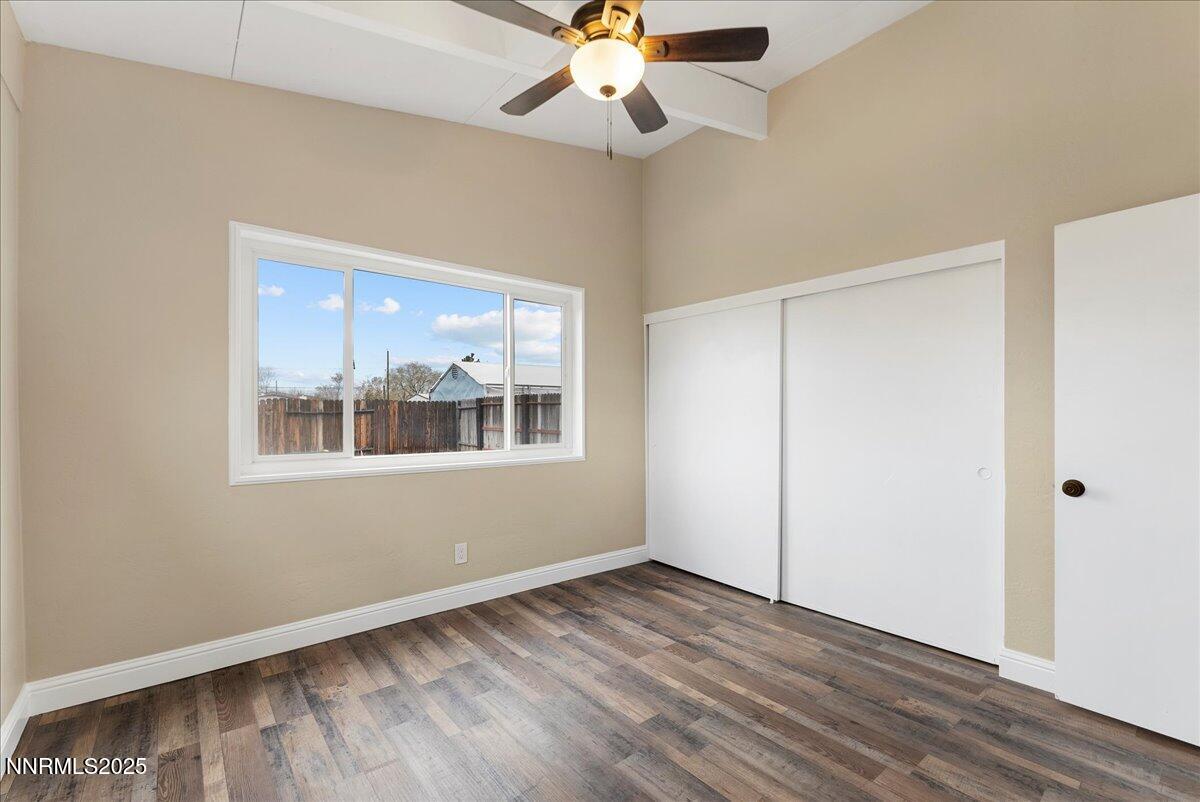 11642 Green Mountain Street Reno, NV 89506 - Photo 13 of 20 a view of an empty room with wooden floor and a window