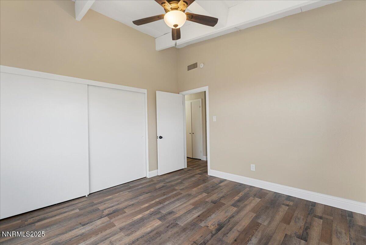 11642 Green Mountain Street Reno, NV 89506 - Photo 14 of 20 an empty room with a ceiling fan and wooden floor
