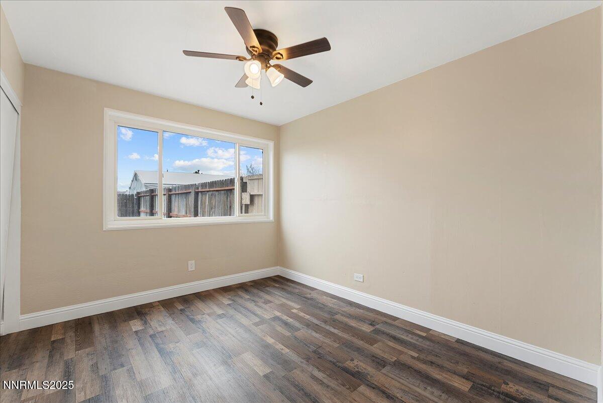 11642 Green Mountain Street Reno, NV 89506 - Photo 16 of 20 a view of an empty room with a window and a ceiling fan
