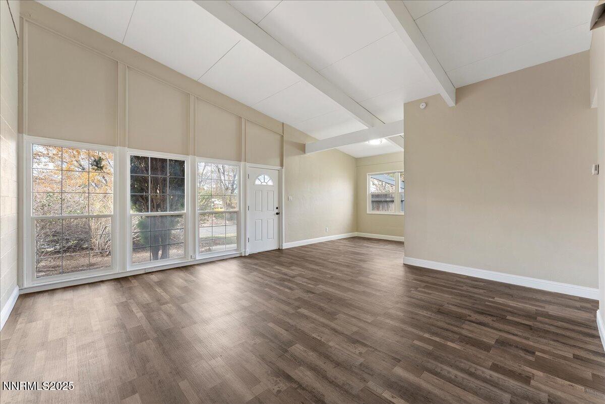 11642 Green Mountain Street Reno, NV 89506 - Photo 5 of 20 a view of an empty room with wooden floor and a window