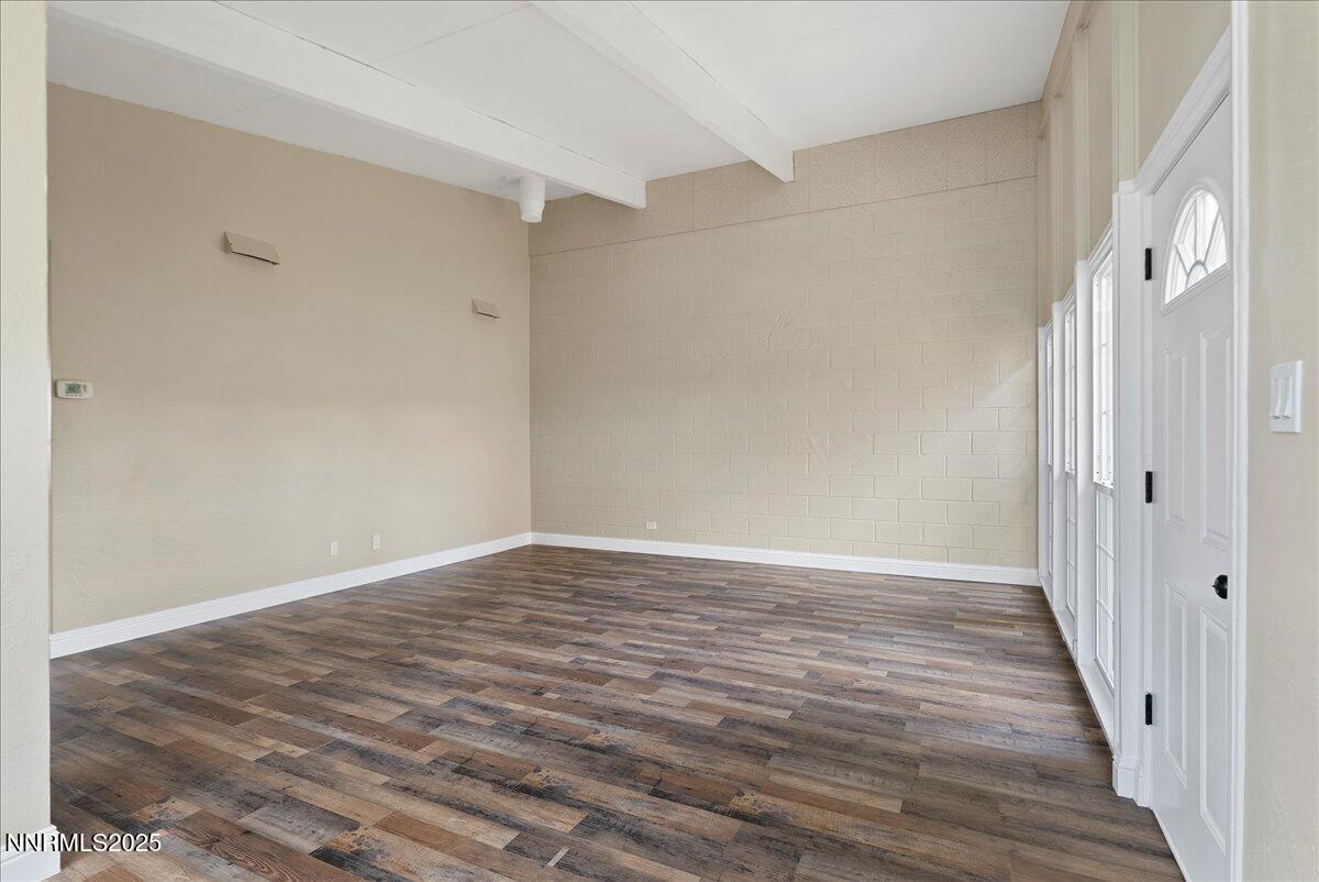 11642 Green Mountain Street Reno, NV 89506 - Photo 6 of 20 a view of an empty room with wooden floor and a window