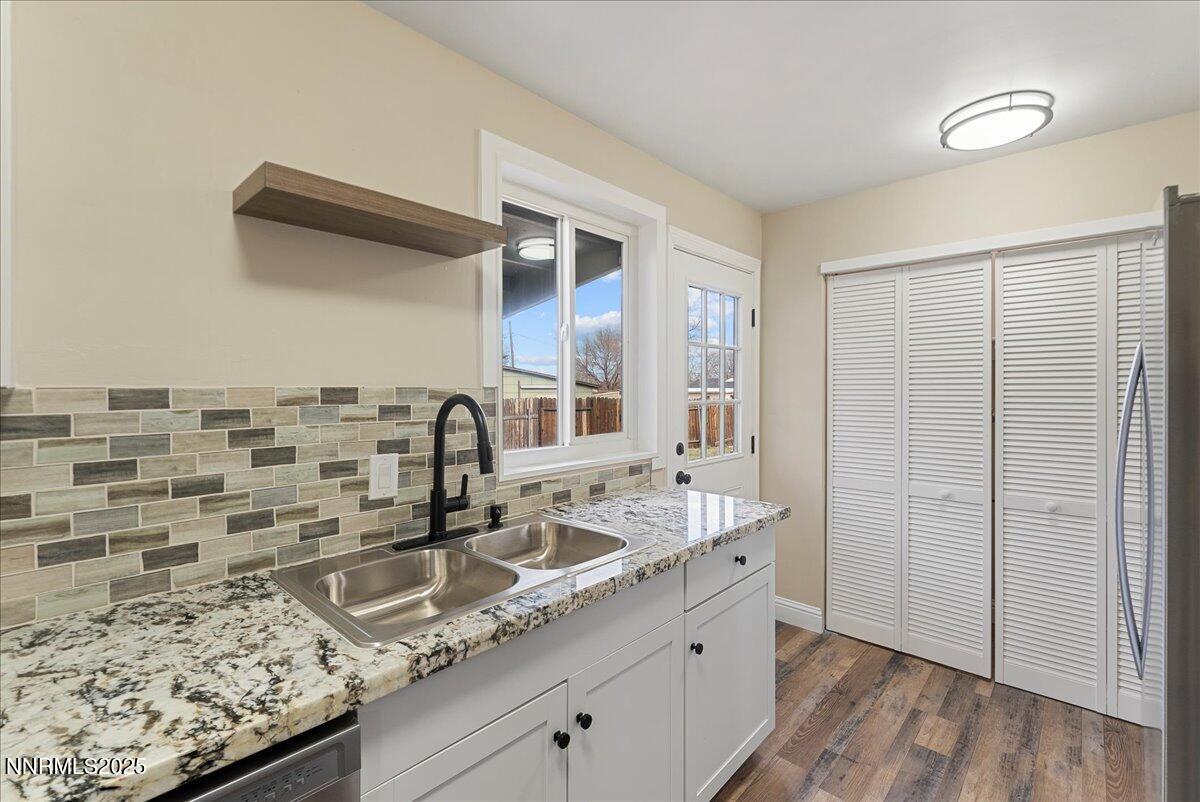 11642 Green Mountain Street Reno, NV 89506 - Photo 9 of 20 a bathroom with a granite countertop sink and a mirror