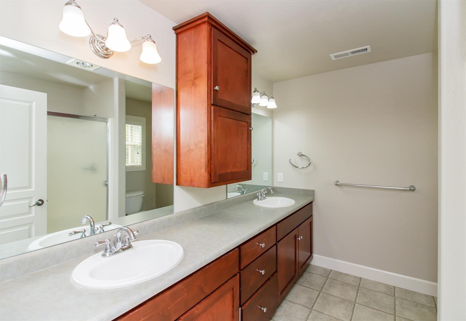 1135 Rustler Peak Street Central Point, OR 97502 - Photo 10 of 17 a bathroom with a granite countertop sink and a mirror
