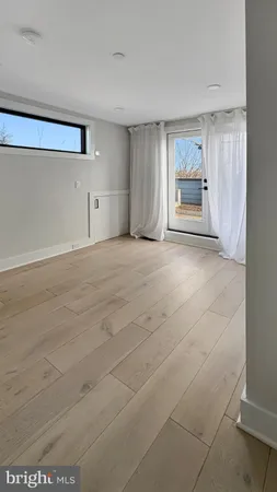 a view of empty room with a fireplace and windows