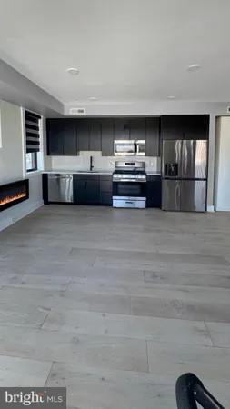 a view of an empty room with a fireplace and a large window