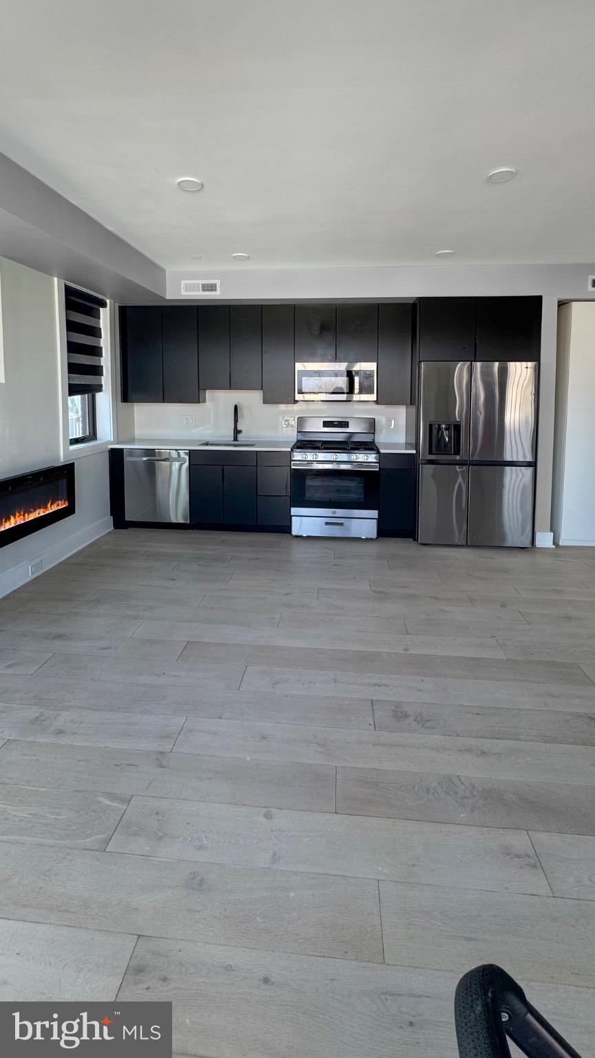 1026 18th Street Northeast, Unit PH6 Washington, DC 20002 - Photo 10 of 11 Modern kitchen with electric fireplace