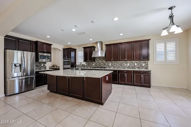 a kitchen with stainless steel appliances granite countertop a sink and cabinets