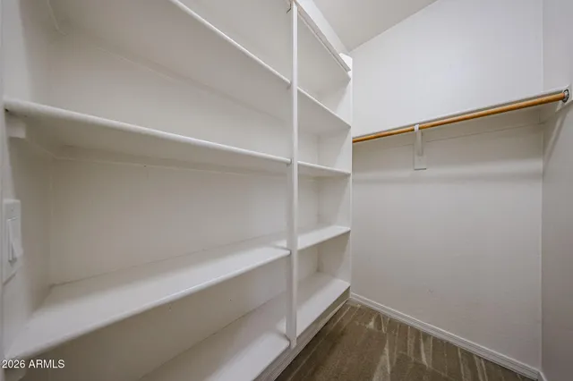 a view of a hallway with entryway and chandelier