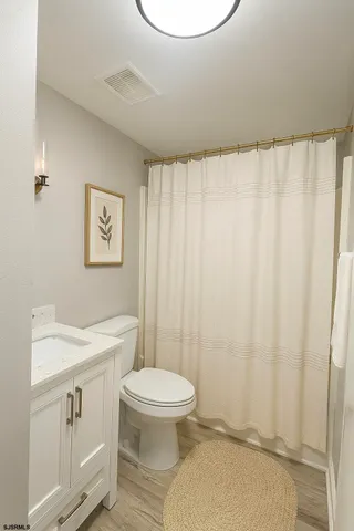 a bathroom with a toilet a sink and a shower