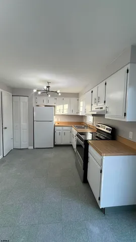a kitchen with stainless steel appliances and white cabinets