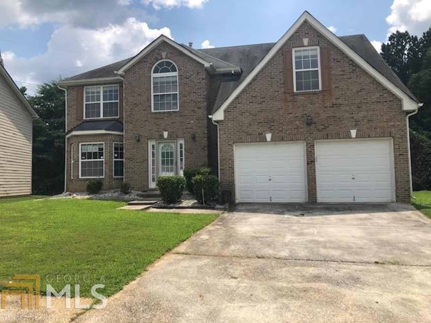 6302 Shell Drive Southwest Atlanta, GA 30331 - Photo 1 of 1 a front view of a house with a yard and garage