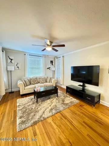 a living room with furniture and a flat screen tv