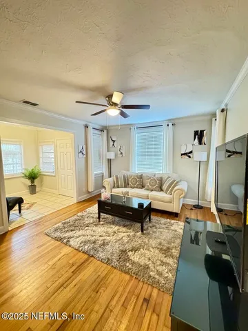 a living room with furniture and a rug