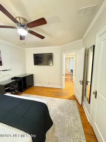 a bedroom with a bed and a large walk in closet